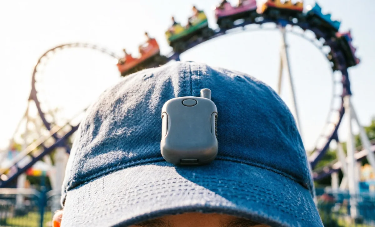 GPS tracker clipped to child’s hat — the best theme park tracker for kids who refuse to wear a watch.